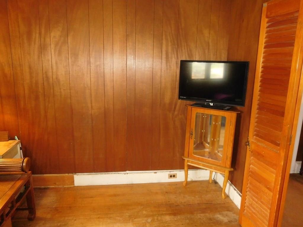19 Juniper Street Lowell, MA 01852 - Photo 17 of 24 a living room with a flat screen tv and a door