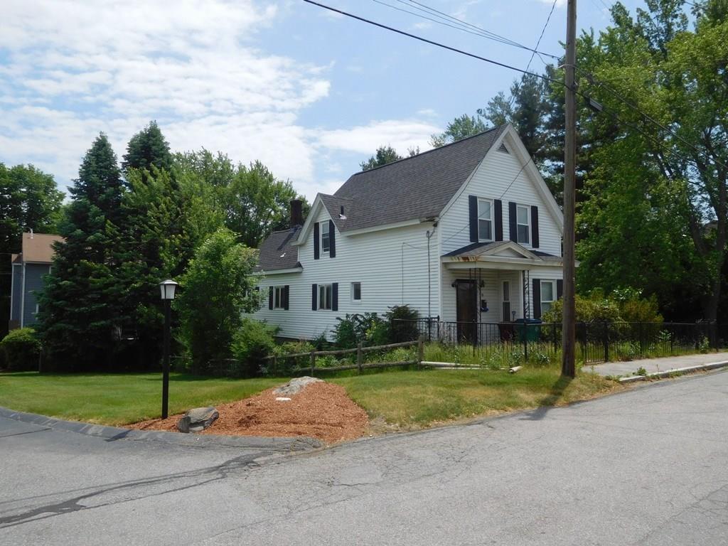 19 Juniper Street Lowell, MA 01852 - Photo 3 of 24 a front view of a house with a yard