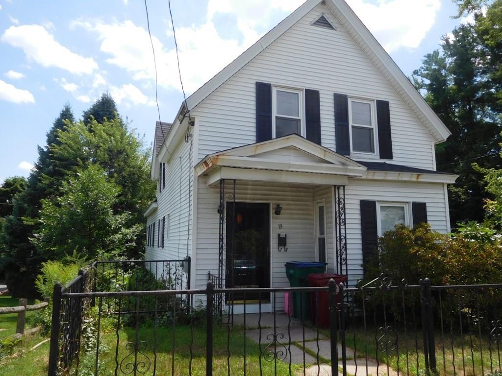 19 Juniper Street Lowell, MA 01852 - Photo 4 of 24 a front view of a house with a yard