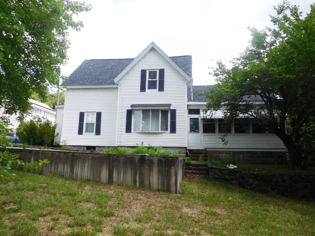 19 Juniper Street Lowell, MA 01852 - Photo 6 of 24 a front view of a house with a yard
