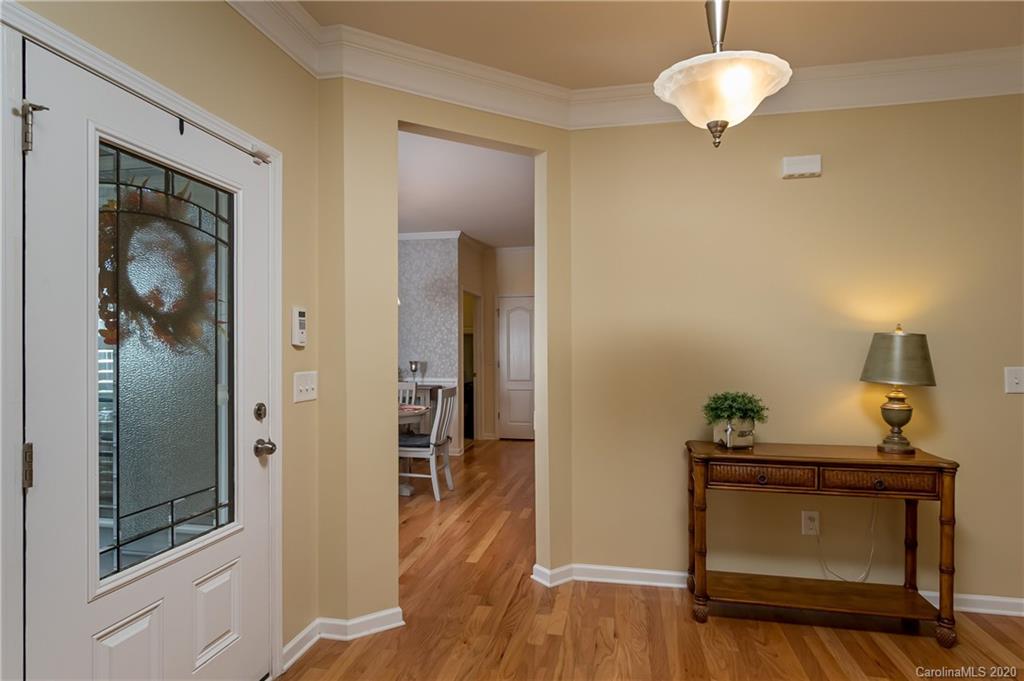 4344 Perth Road, Unit 240 Indian Land, SC 29707 - Photo 5 of 30 a view of a hallway with wooden floor and a cabinet