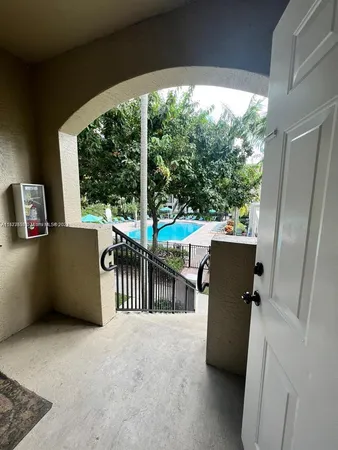 a view of a patio with a table and chairs