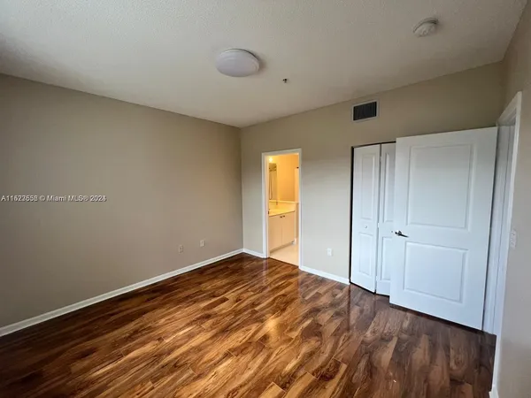 a bathroom with a sink a toilet a mirror and shower