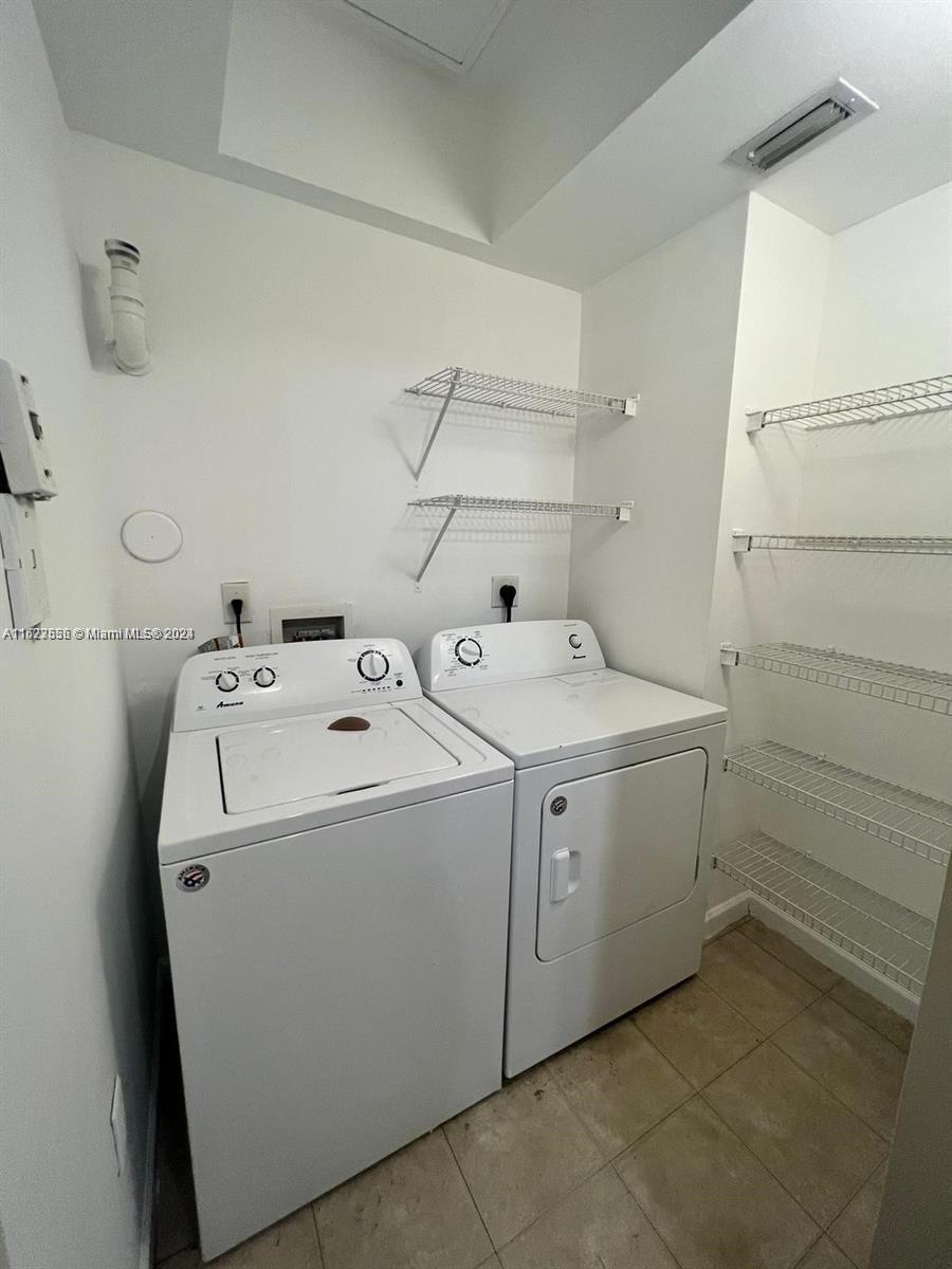 5940 West Sample Road, Unit 304 Coral Springs, FL 33067 - Photo 9 of 18 a utility room with dryer and washer