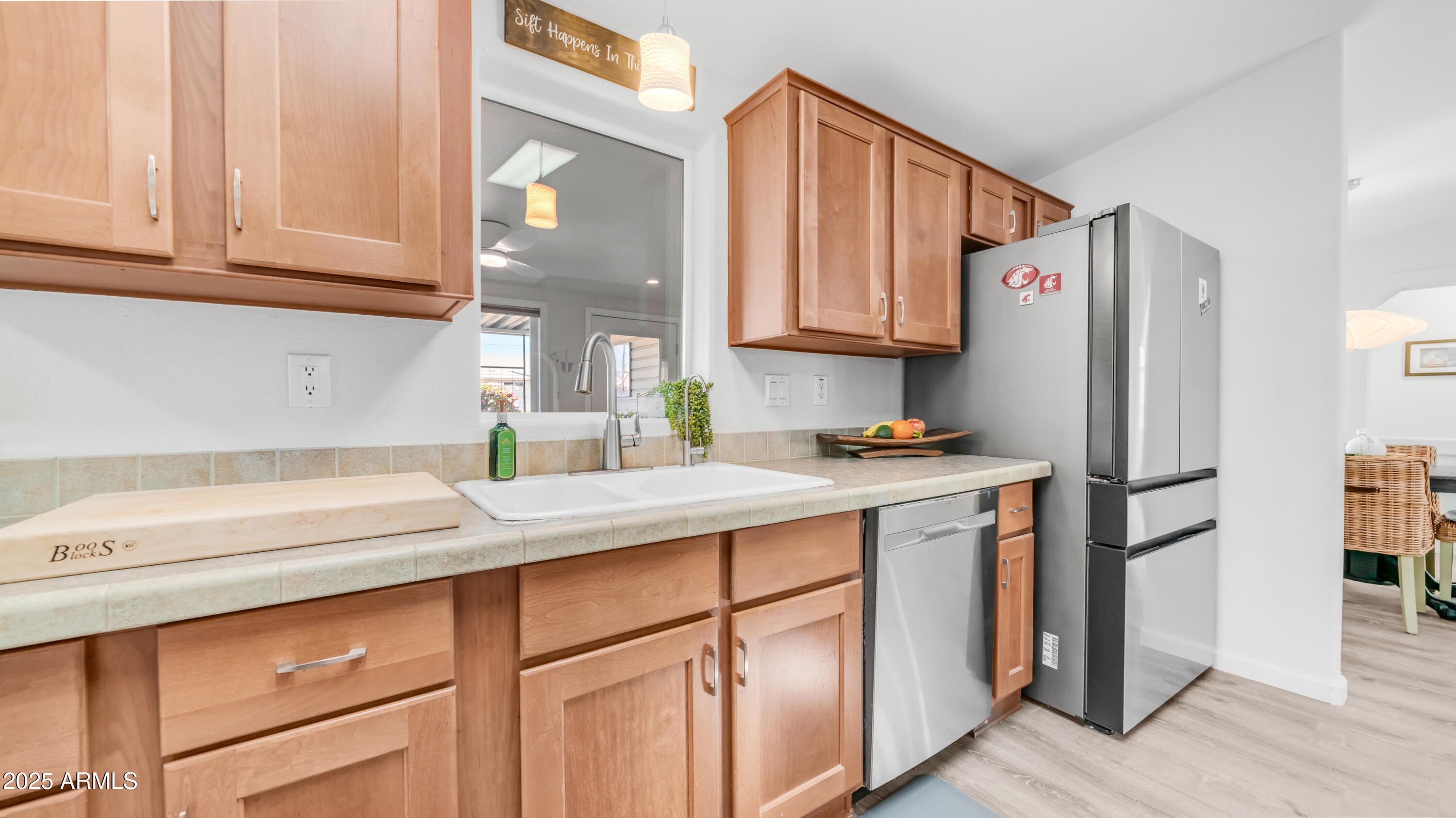 2550 South Ellsworth Road, Unit 751 Mesa, AZ 85209 - Photo 9 of 27 a kitchen with stainless steel appliances granite countertop a refrigerator sink and white cabinets