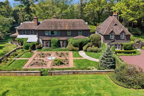 a view of house with garden space and trees