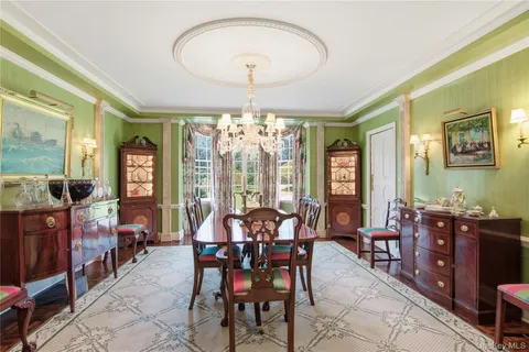 a view of a dining room with furniture and chandelier