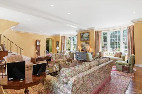 a kitchen with stainless steel appliances granite countertop a table chairs sink and cabinets
