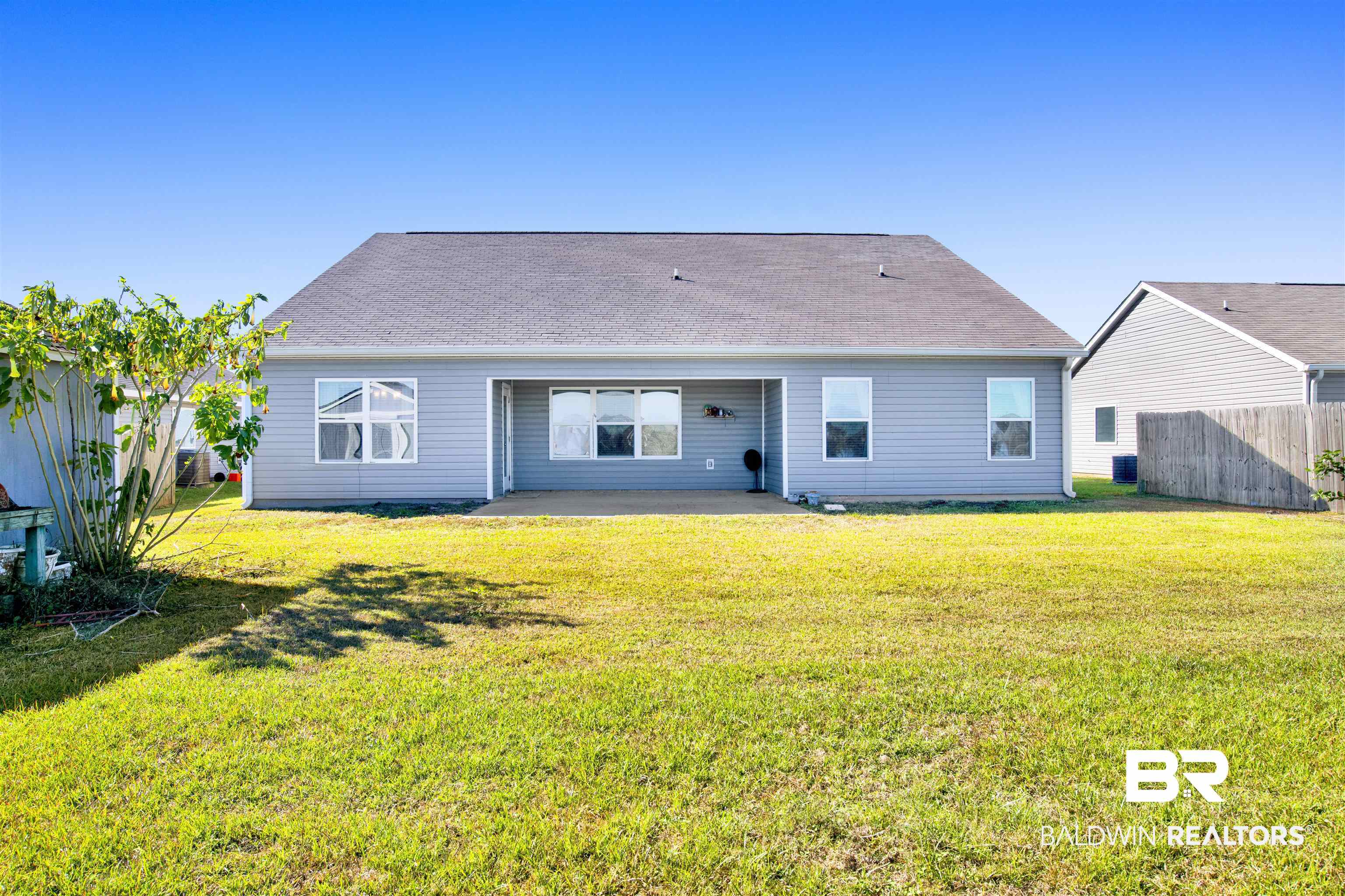6926 Crimson Ridge Street Gulf Shores, AL 36542 - Photo 18 of 18 Back of property featuring a patio area and a shingled roof