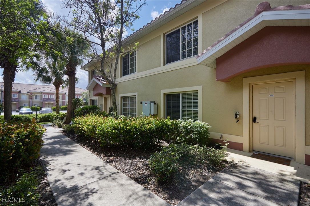 9460 Ivy Brook Run, Unit 710 Fort Myers, FL 33913 - Photo 13 of 23 a front view of a house with garden