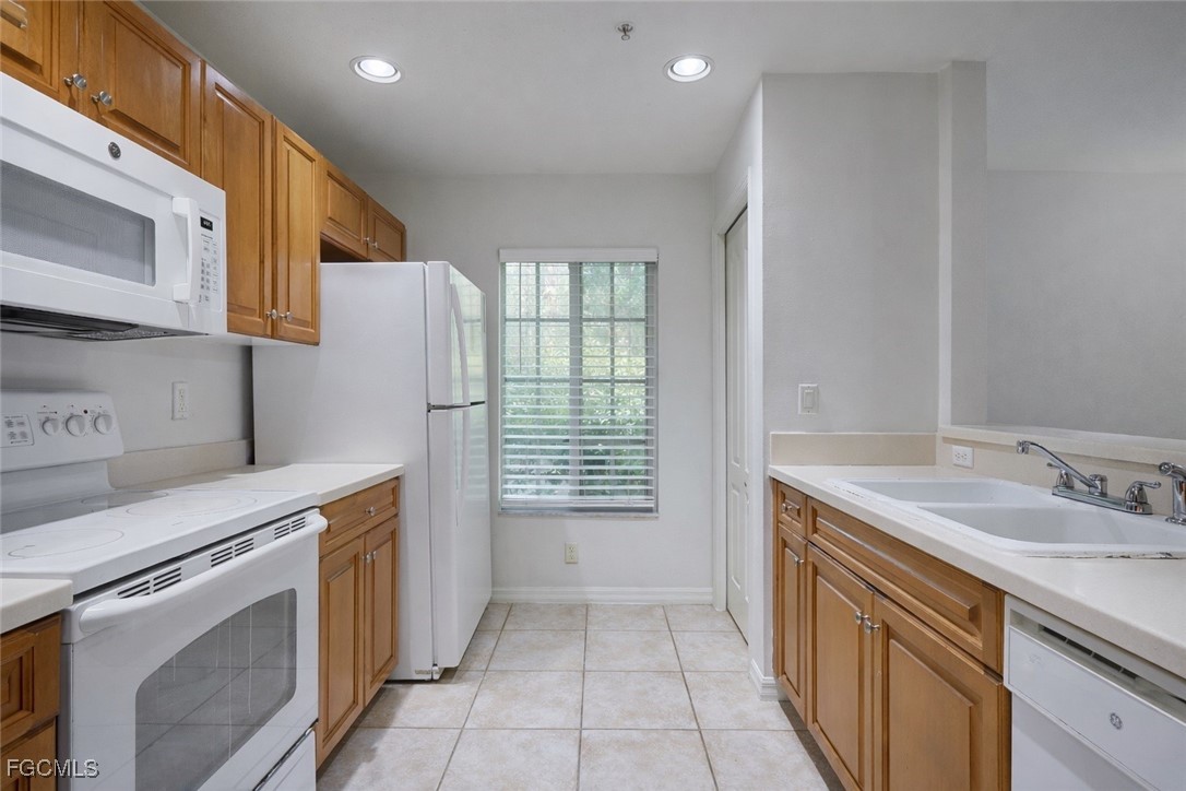9460 Ivy Brook Run, Unit 710 Fort Myers, FL 33913 - Photo 3 of 23 a kitchen with a sink stove and refrigerator