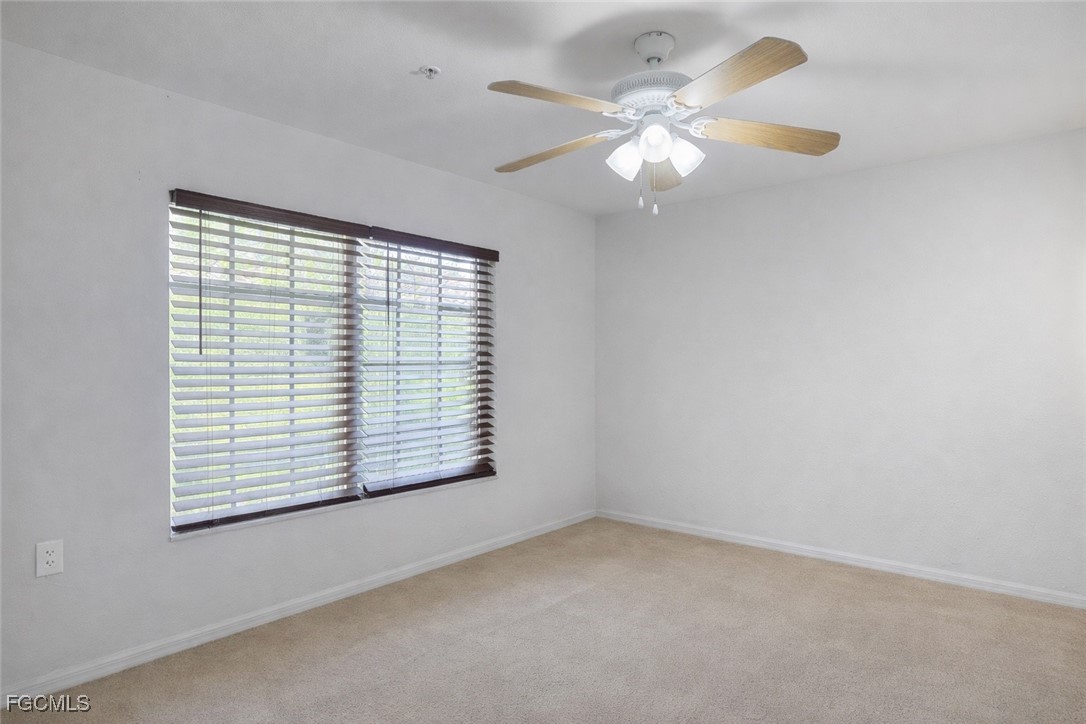 9460 Ivy Brook Run, Unit 710 Fort Myers, FL 33913 - Photo 4 of 23 an empty room with windows and fan