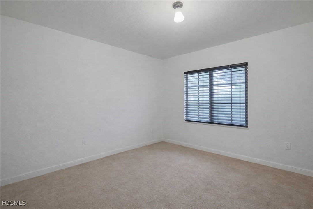 9460 Ivy Brook Run, Unit 710 Fort Myers, FL 33913 - Photo 5 of 23 an empty room with a window