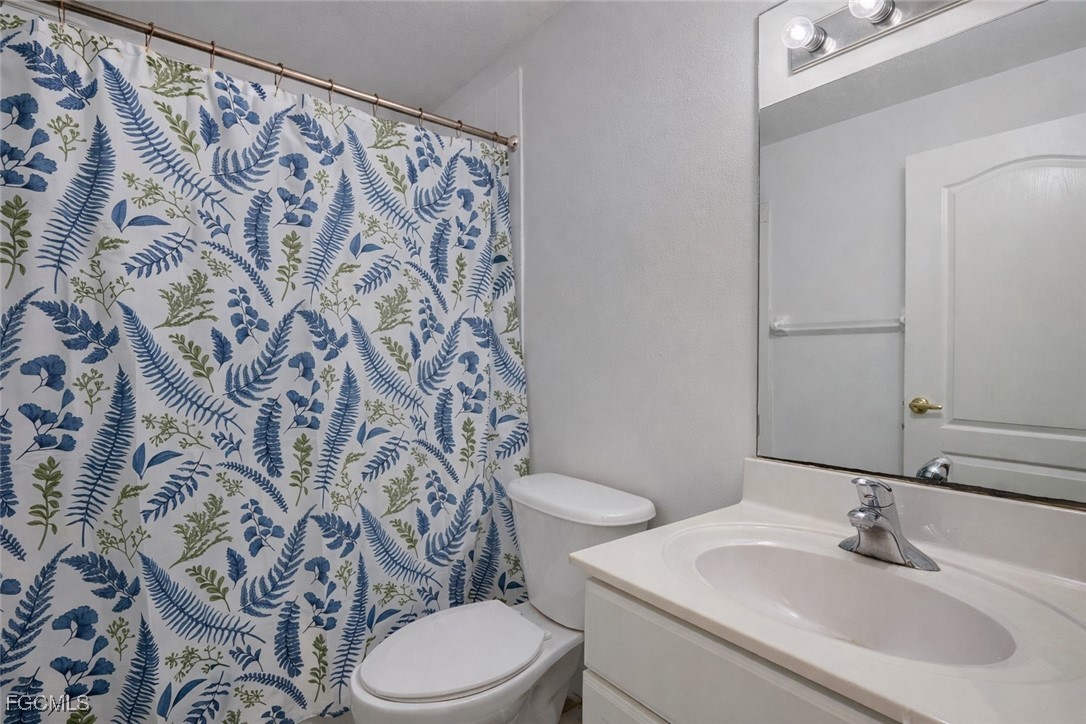 9460 Ivy Brook Run, Unit 710 Fort Myers, FL 33913 - Photo 8 of 23 a bathroom with a sink and a toilet