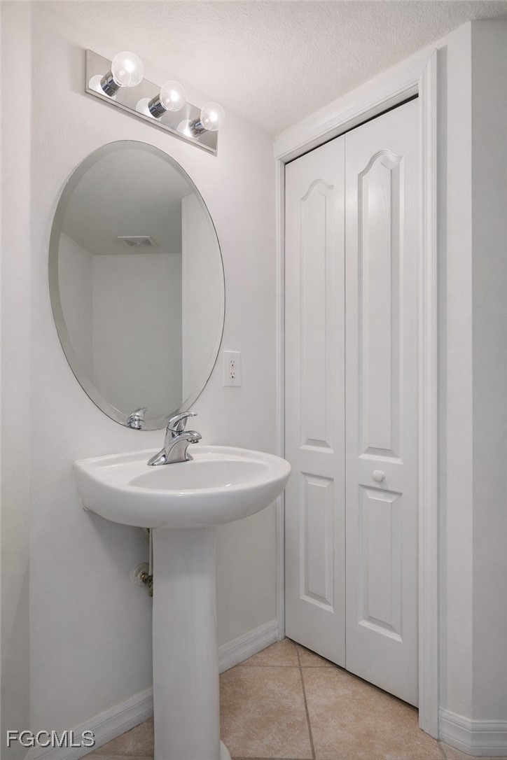 9460 Ivy Brook Run, Unit 710 Fort Myers, FL 33913 - Photo 9 of 23 a bathroom with a sink a vanity and a mirror