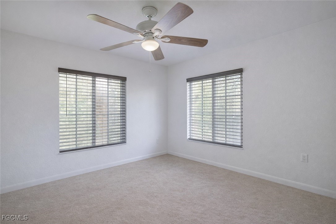 9460 Ivy Brook Run, Unit 710 Fort Myers, FL 33913 - Photo 10 of 23 an empty room with windows and fan