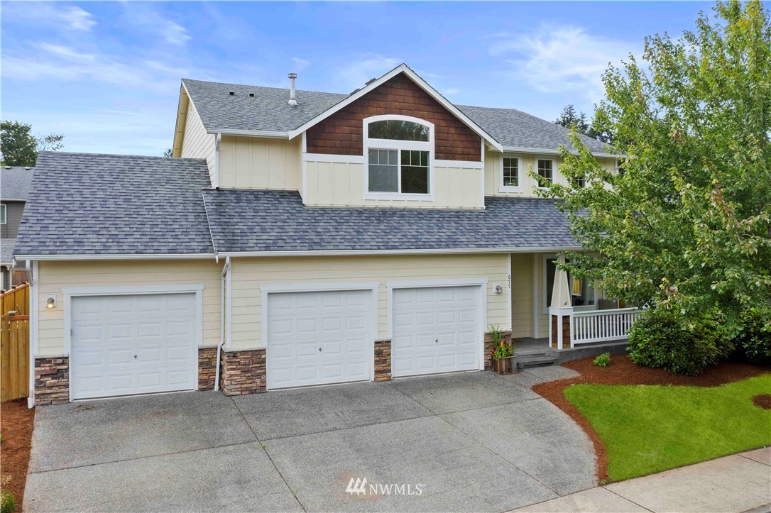 a front view of a house with garage