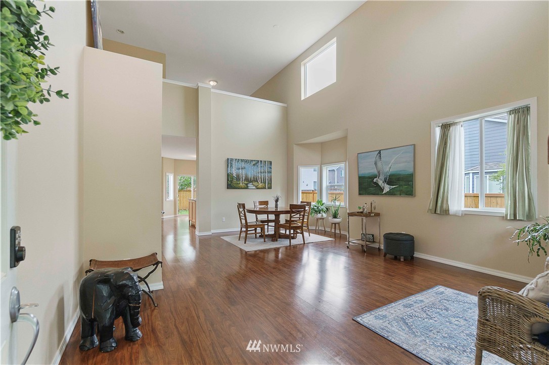 677 Shadow Avenue Northeast Renton, WA 98059 - Photo 4 of 40 a living room with furniture and a wooden floor