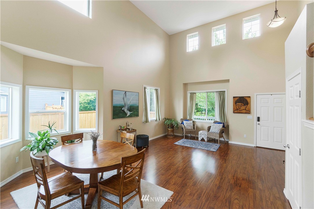677 Shadow Avenue Northeast Renton, WA 98059 - Photo 7 of 40 a view of a dining room with furniture window and wooden floor