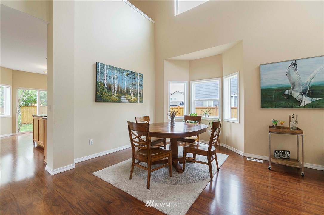 677 Shadow Avenue Northeast Renton, WA 98059 - Photo 8 of 40 a view of a dining room with furniture and wooden floor