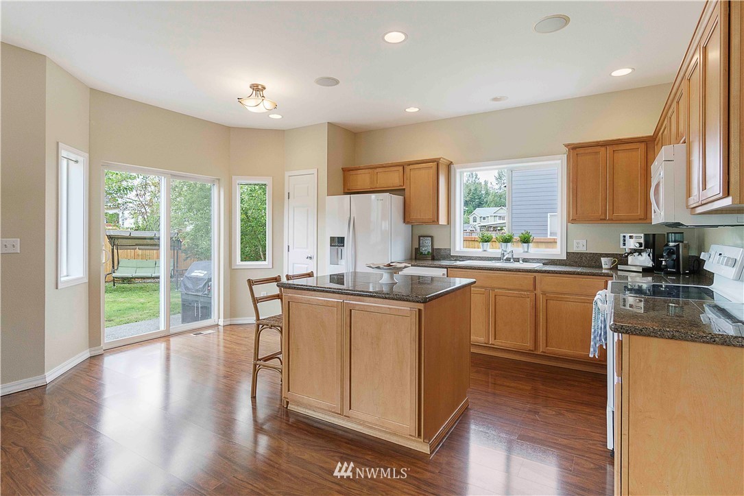 677 Shadow Avenue Northeast Renton, WA 98059 - Photo 9 of 40 a kitchen with sink a window and cabinets