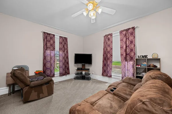 a dining room with wooden floor a chandelier a wooden table and chairs