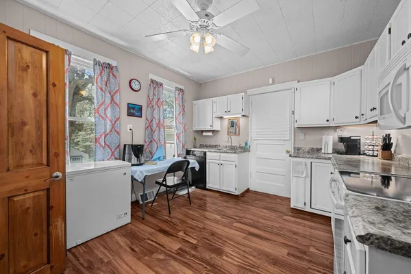 a bedroom with a bed and a flat tv screen on dresser