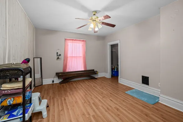 a view of a livingroom with wooden floor and a chandelier