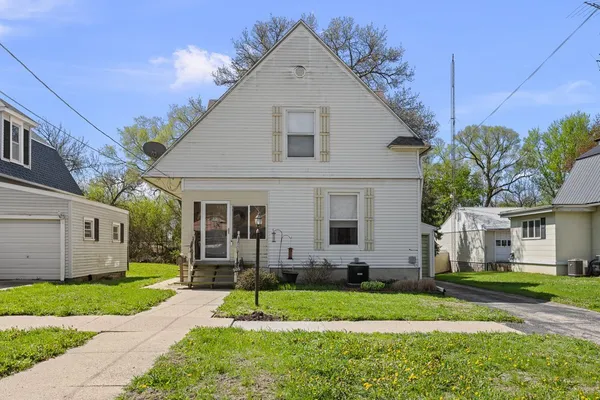 a view of a yard in front view of a house