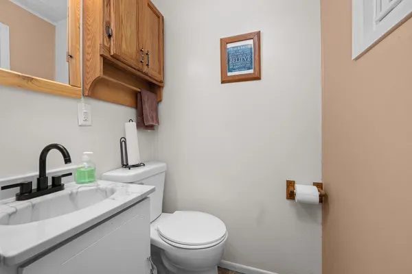 a bathroom with a toilet a sink and a mirror