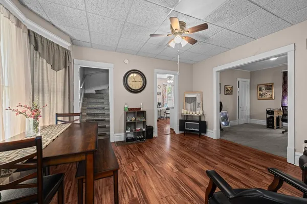 a living room with furniture and a dining table with chair