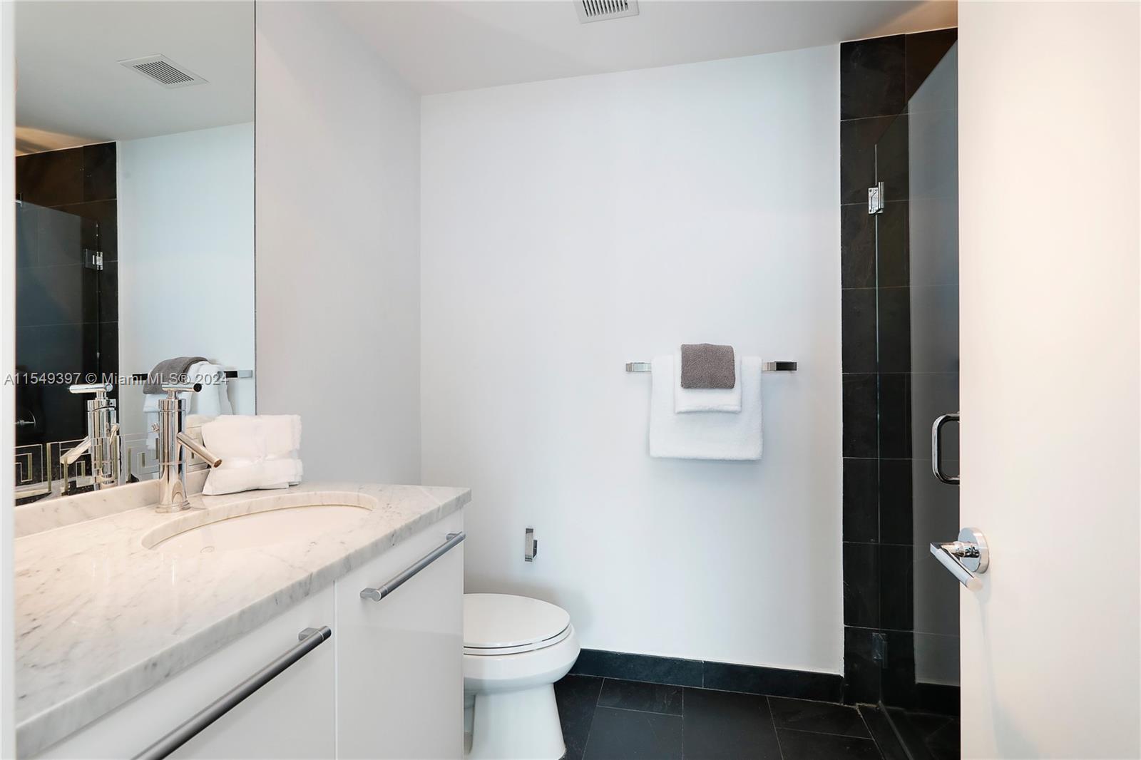 900 Biscayne Boulevard, Unit 705 Miami, FL 33132 - Photo 13 of 30 a bathroom with a sink and a toilet