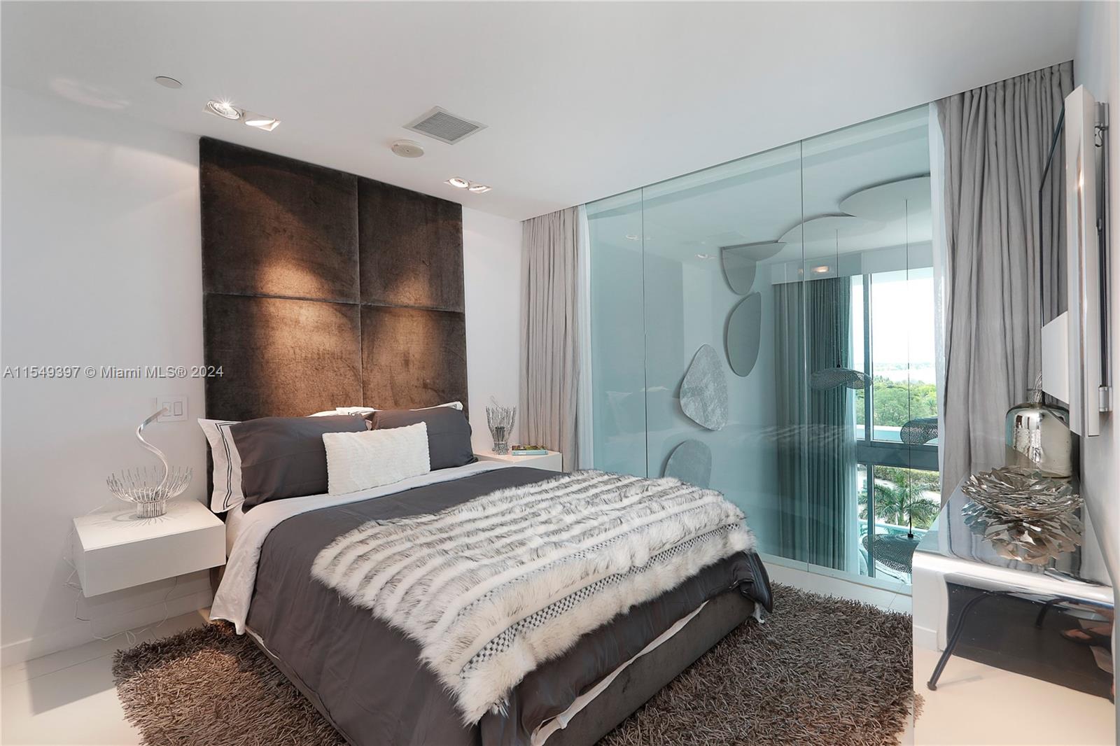 900 Biscayne Boulevard, Unit 705 Miami, FL 33132 - Photo 24 of 30 a bedroom with a large bed and a large window