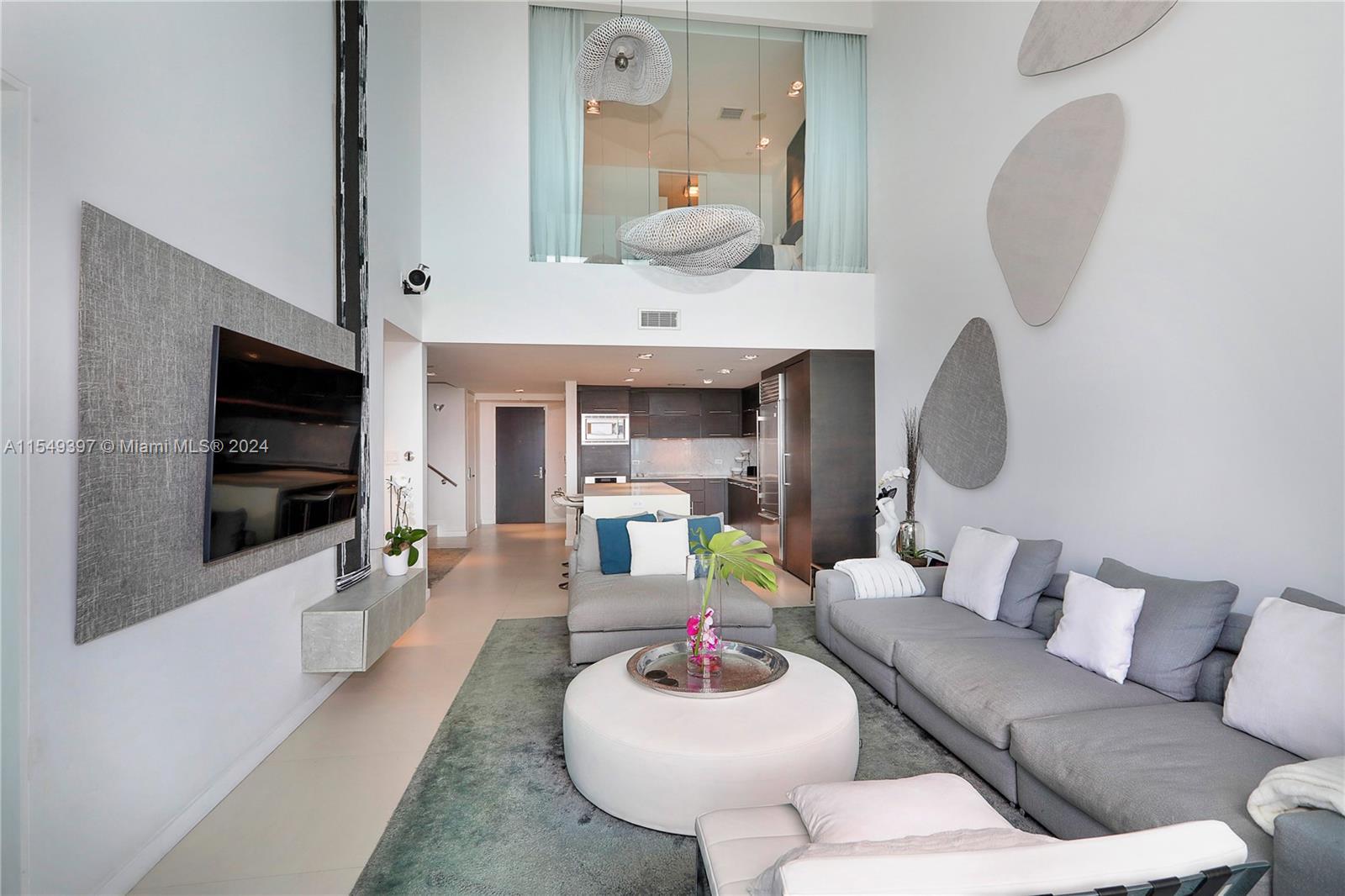 900 Biscayne Boulevard, Unit 705 Miami, FL 33132 - Photo 27 of 30 a living room with furniture and a flat screen tv