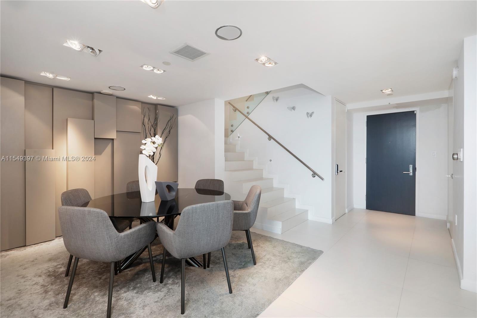 900 Biscayne Boulevard, Unit 705 Miami, FL 33132 - Photo 5 of 30 a dining room with furniture and wooden floor