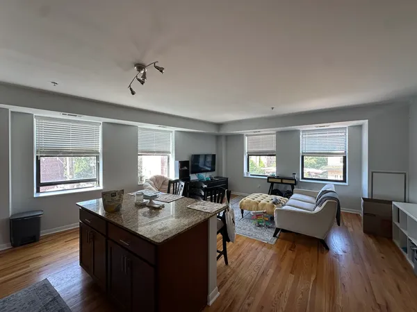 a view of living room filled with furniture and wooden floor