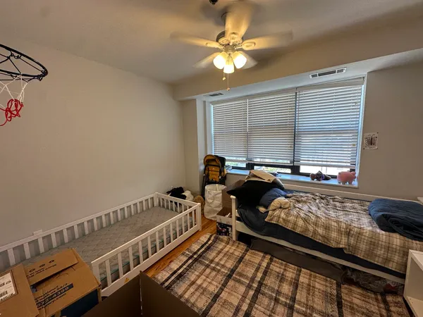 a bed sitting in a bedroom next to a window