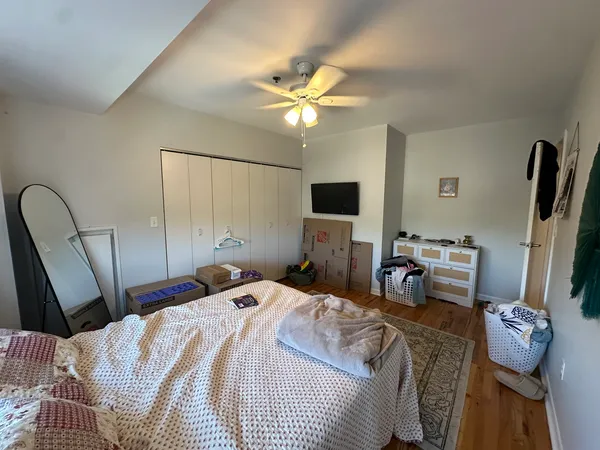 a bedroom with a bed and a chandelier