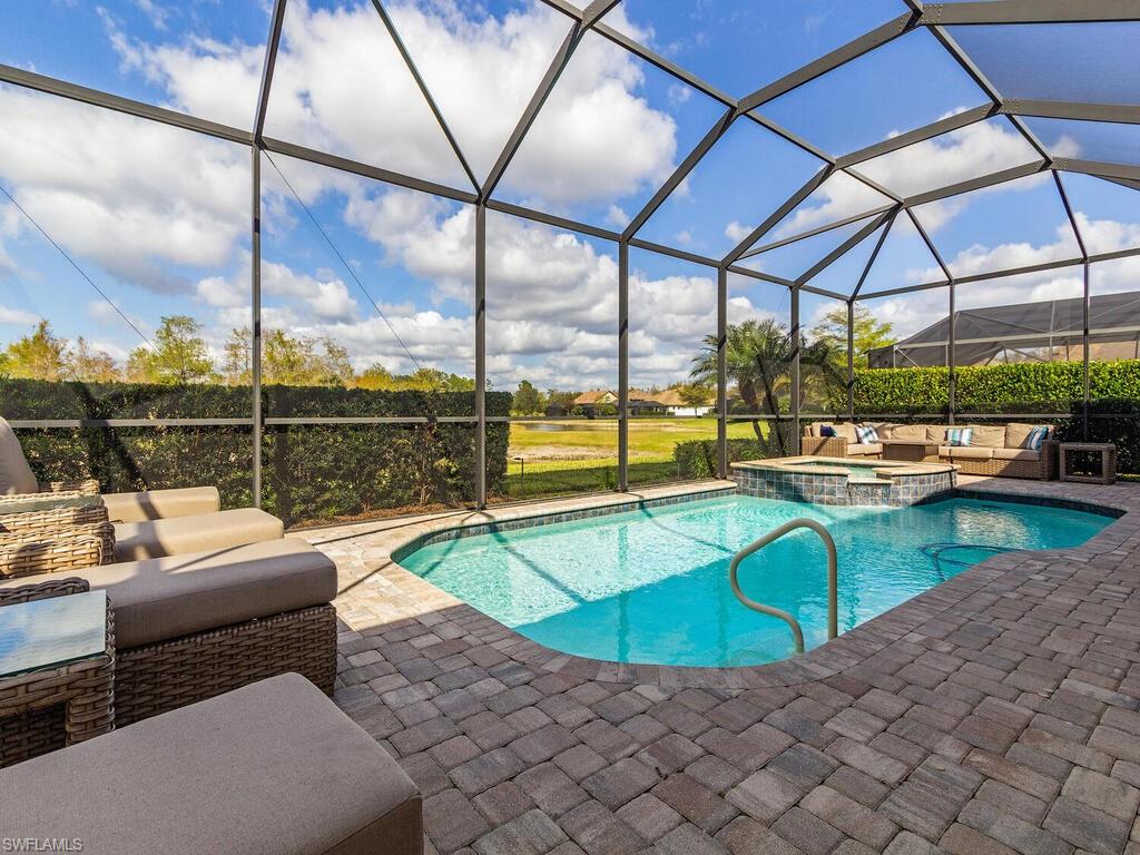 7263 Clamshell Lane Naples, FL 34114 - Photo 11 of 11 a view of a swimming pool with a couches chairs and sitting area