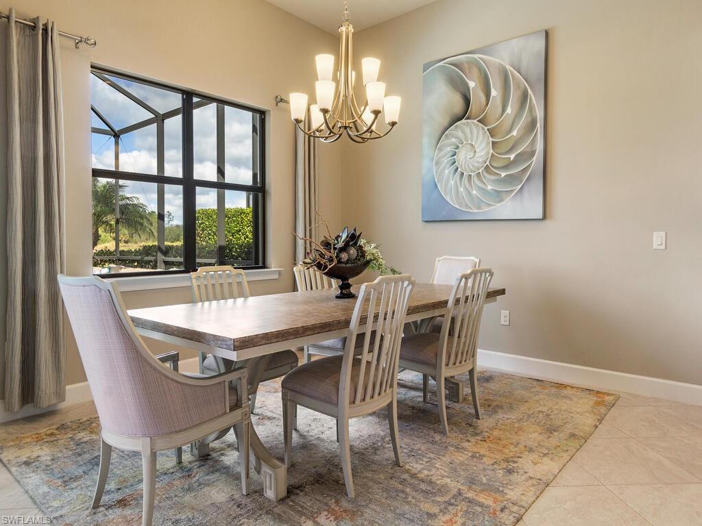7263 Clamshell Lane Naples, FL 34114 - Photo 3 of 11 a dining room with furniture a rug and a chandelier
