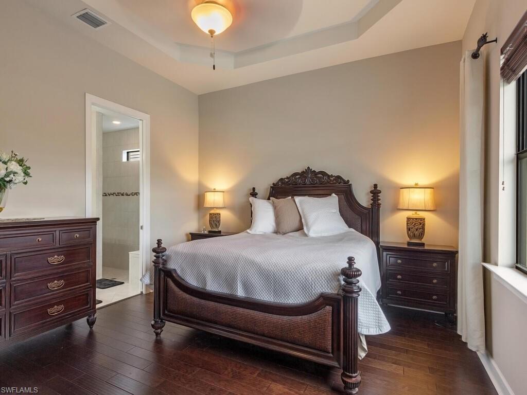 7263 Clamshell Lane Naples, FL 34114 - Photo 6 of 11 a bedroom with a bed and wooden floor