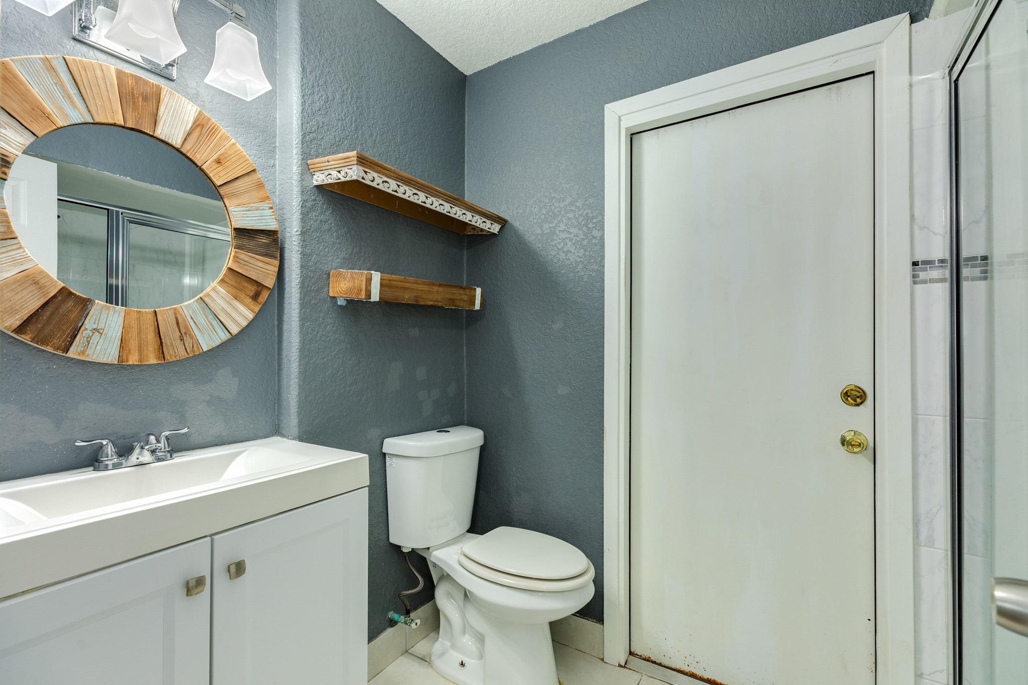 128 Houston Street Angleton, TX 77515 - Photo 23 of 25 a bathroom with a sink toilet and mirror