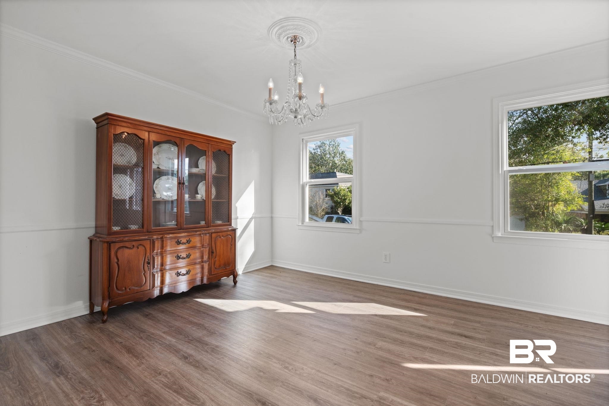 511 Wacker Lane North Mobile, AL 36608 - Photo 18 of 45 Unfurnished dining area featuring a chandelier, dark wood-style floors, and crown molding