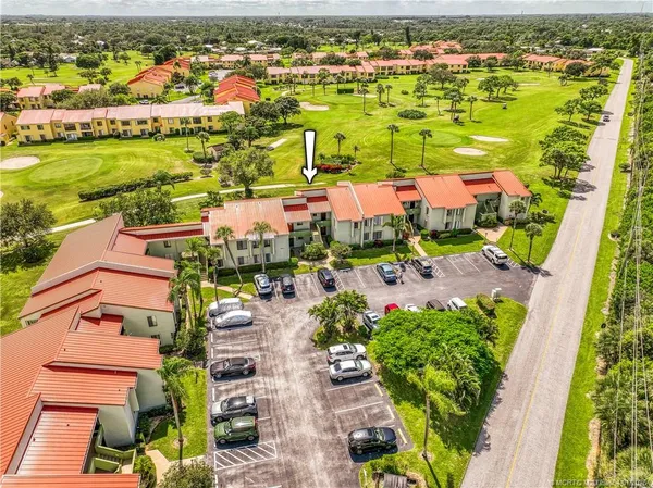 an aerial view of residential houses with outdoor space and city view