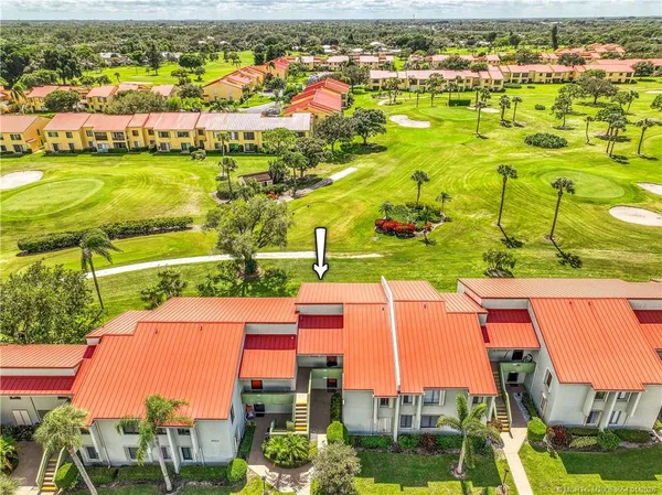 an aerial view of residential houses with outdoor space and swimming pool