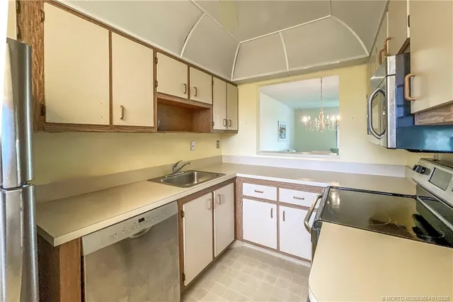 a utility room with sink dryer and washer