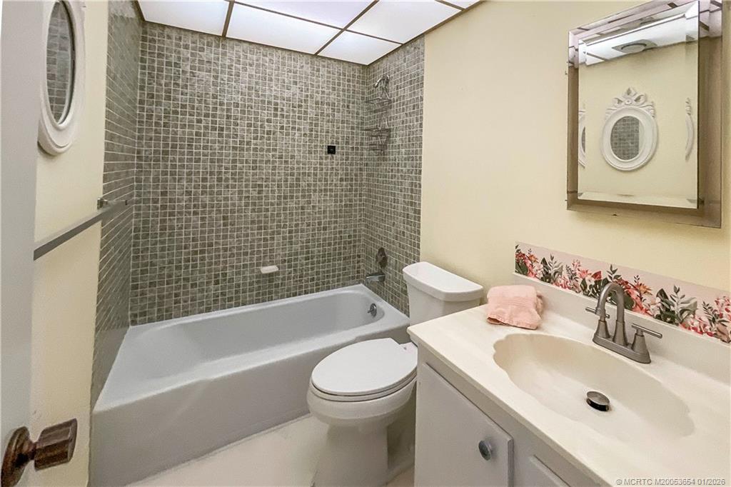 5403 Southeast Miles Grant Road, Unit 209 Stuart, FL 34997 - Photo 9 of 18 a bathroom with a sink a toilet and shower