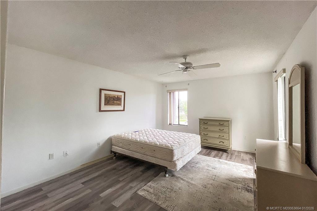5403 Southeast Miles Grant Road, Unit 209 Stuart, FL 34997 - Photo 10 of 18 a spacious bedroom with a bed and a view of bedroom