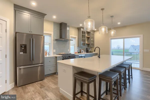 a kitchen with refrigerator a sink and a chandelier