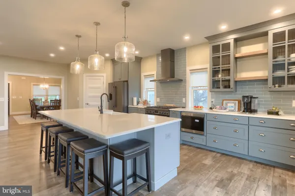 a large kitchen with a table and chairs